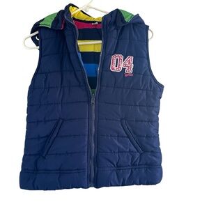 Justice reversible Navy Puffer Vest with Colorful stripes on reverse.